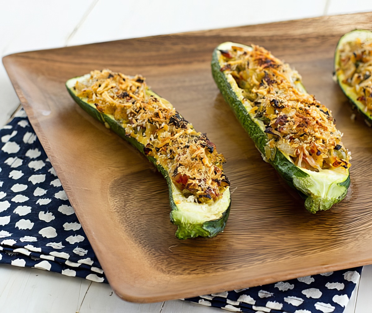 Vegetarian Stuffed Zucchini with Parmesan Panko being served on a wooden plate