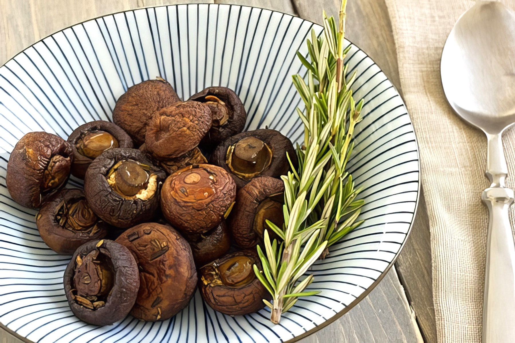 roasted cremini mushrooms in a striped bowl