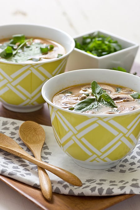 Thai Red Curry Soup being served on a table with yellow bowls