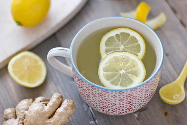 natural calm lemon ginger tea in a white cup with red and blue small triangle patterns