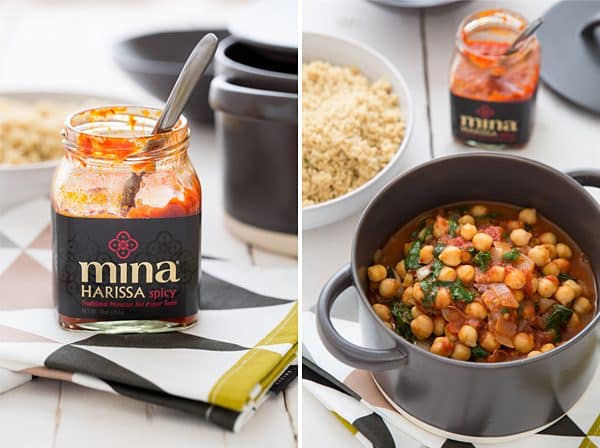 Spicy Chickpea & Spinach Stew cooking in a pot with jar of harissa