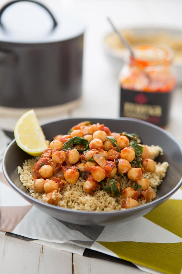 Spicy Chickpea & Spinach Stew with Harissa being served in a grey bowl