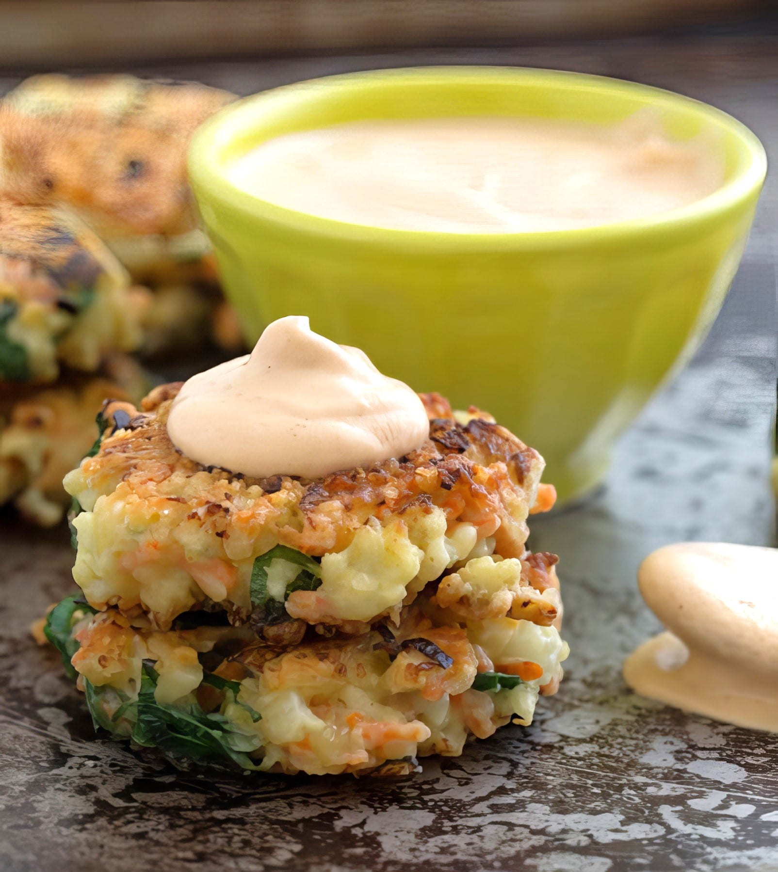 carrot and cauliflower fritters being served with garlic aioli