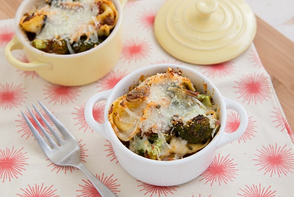 Cheese Tortellini Bake with Roasted Broccoli in white pot with fork