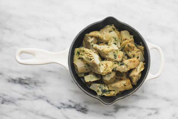 artichokes being prepared for a gratin