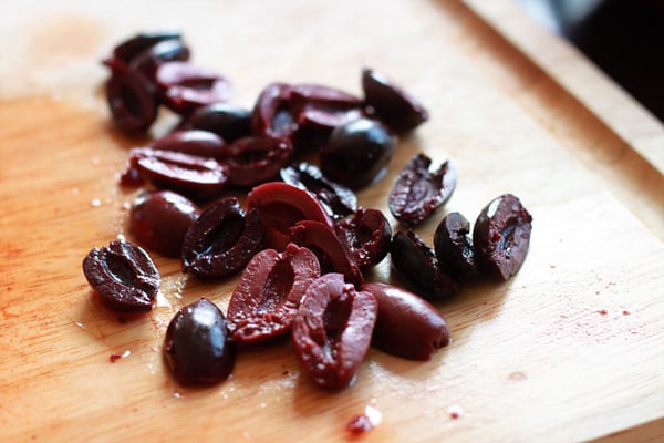 olives on wooden cutting board for Mediterranean vegetarian Calzones