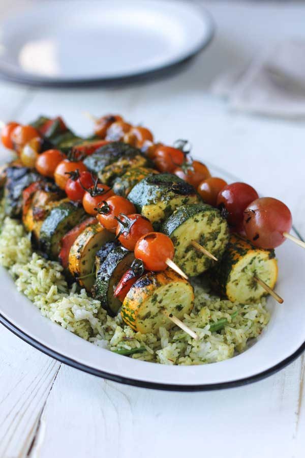 Chermoula Veggie Kebabs with Halloumi being served over rice in a white dish