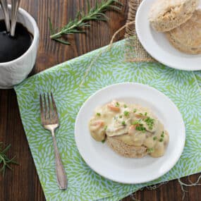 Biscuits and Gravy sitting on white plate with fork