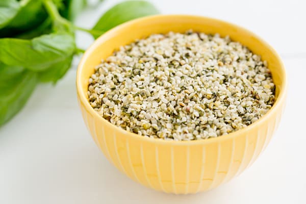 Hemp Seeds in yellow bowl on white background