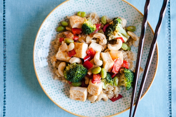 Cashew Tofu Quinoa Bowl with a blue background