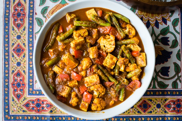 Tofu Vindaloo being served in a white bowl