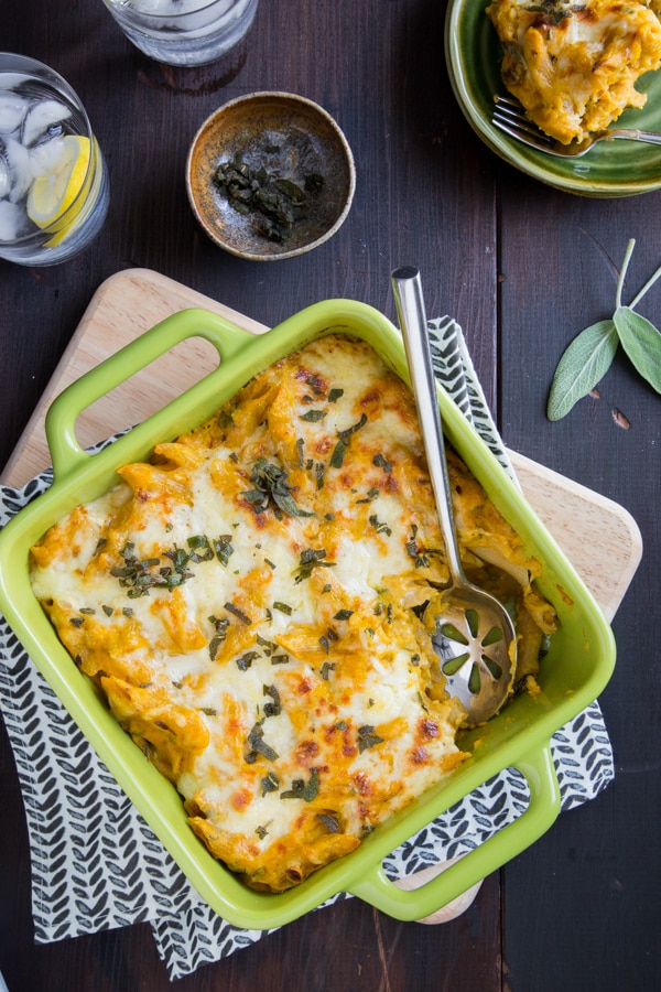 baked pumpkin pasta in a green serving dish