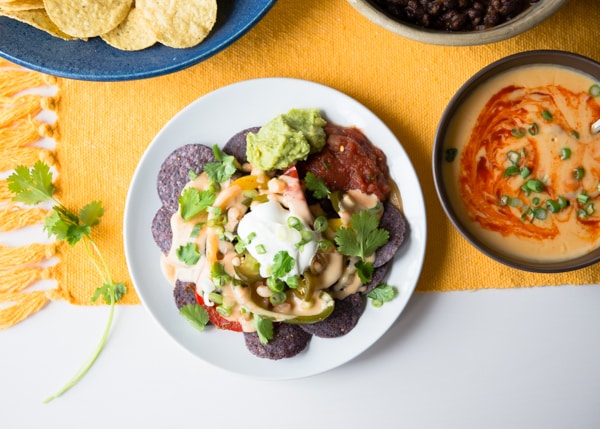 Sriracha Beer Queso vegetarian crockpot appetizer served with chips on a plate