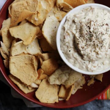 vegan french onion dip being served with pita chips