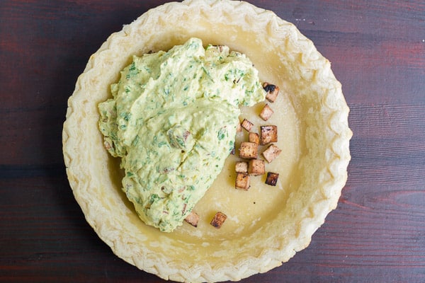 adding the filling to the vegan quiche