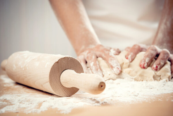 woman kneading dough close up photo
