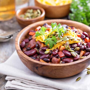 Vegetarian chili with red and black beans, cheddar and pumpkin seeds