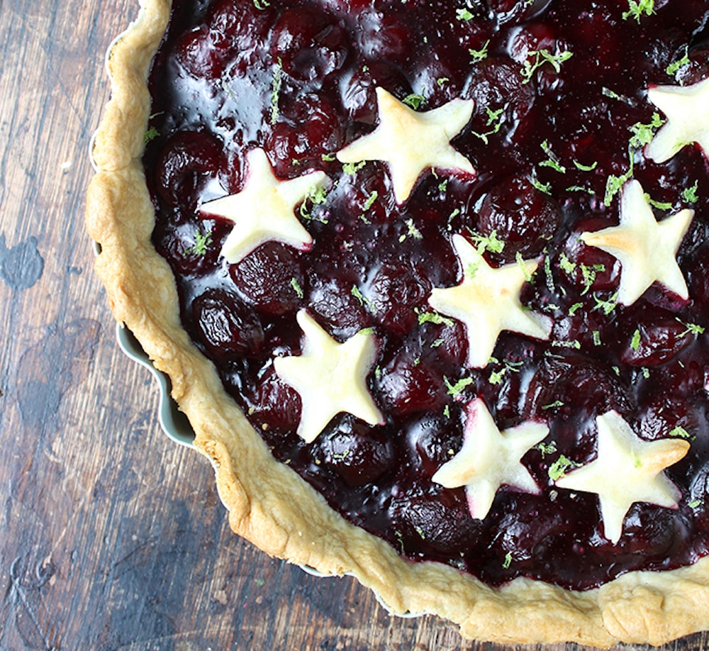 lime and fresh cherry pie on wood with stars by veggie desserts