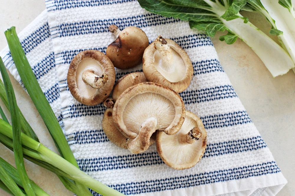 shiitake mushrooms being prepared for the ramen bowls