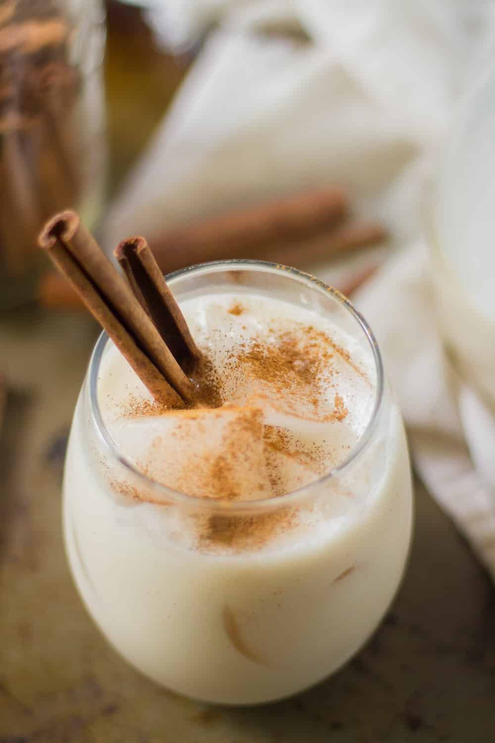 Coconut Horchata in a glass with cinnamon sticks 