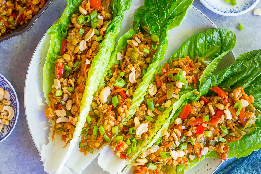 tempeh lettuce wraps being served on a white plate