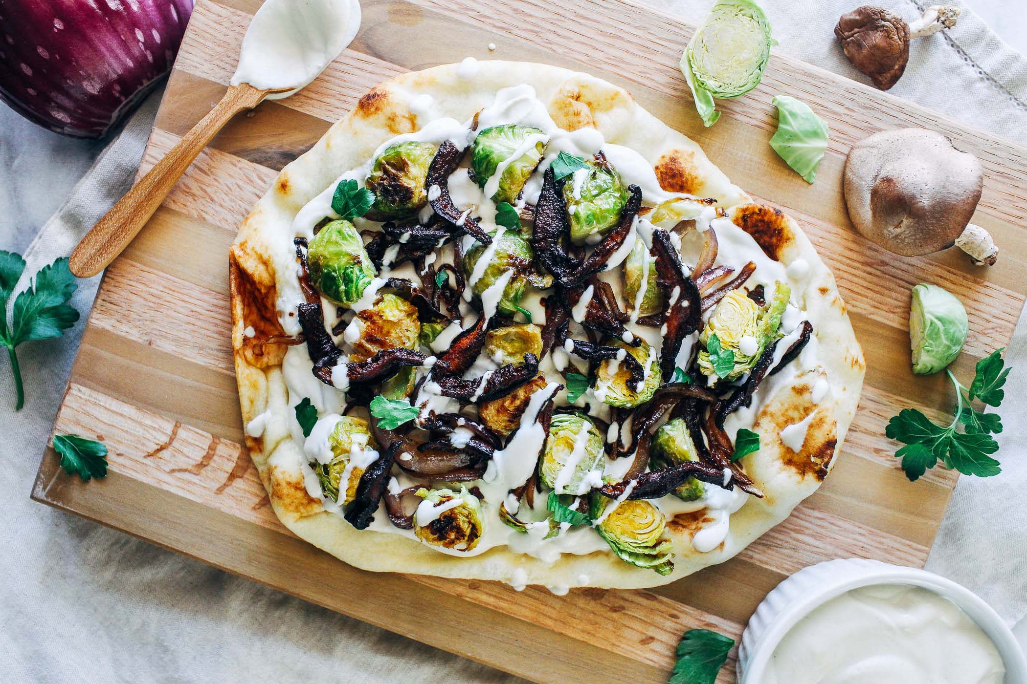 White Garlic Cashew Cream Pizza with Dijon Brussels and Crispy Shiitake Bacon