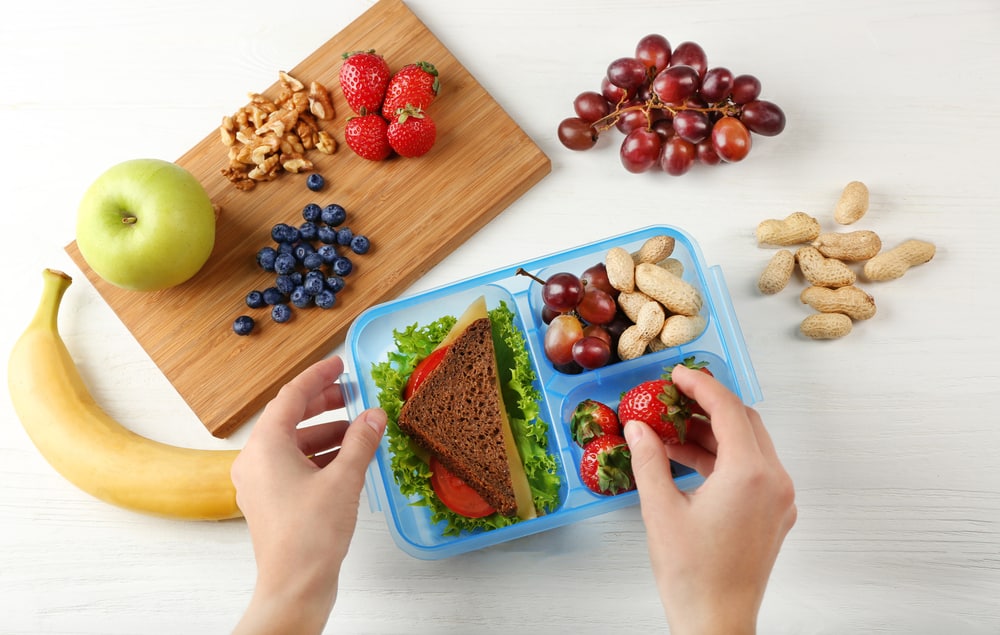 hands packing a lunch box