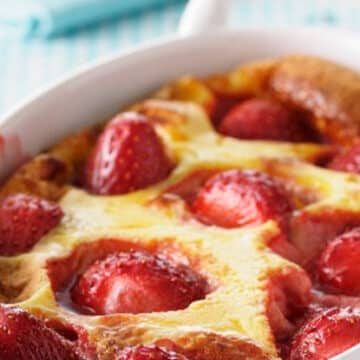 Strawberries rest in a flan pastry topping in a French Clafoutis recipe
