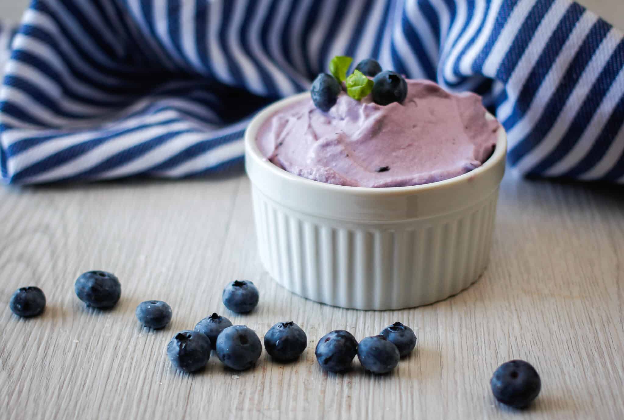 Easy Blueberry Mousse being served in a white ramekin