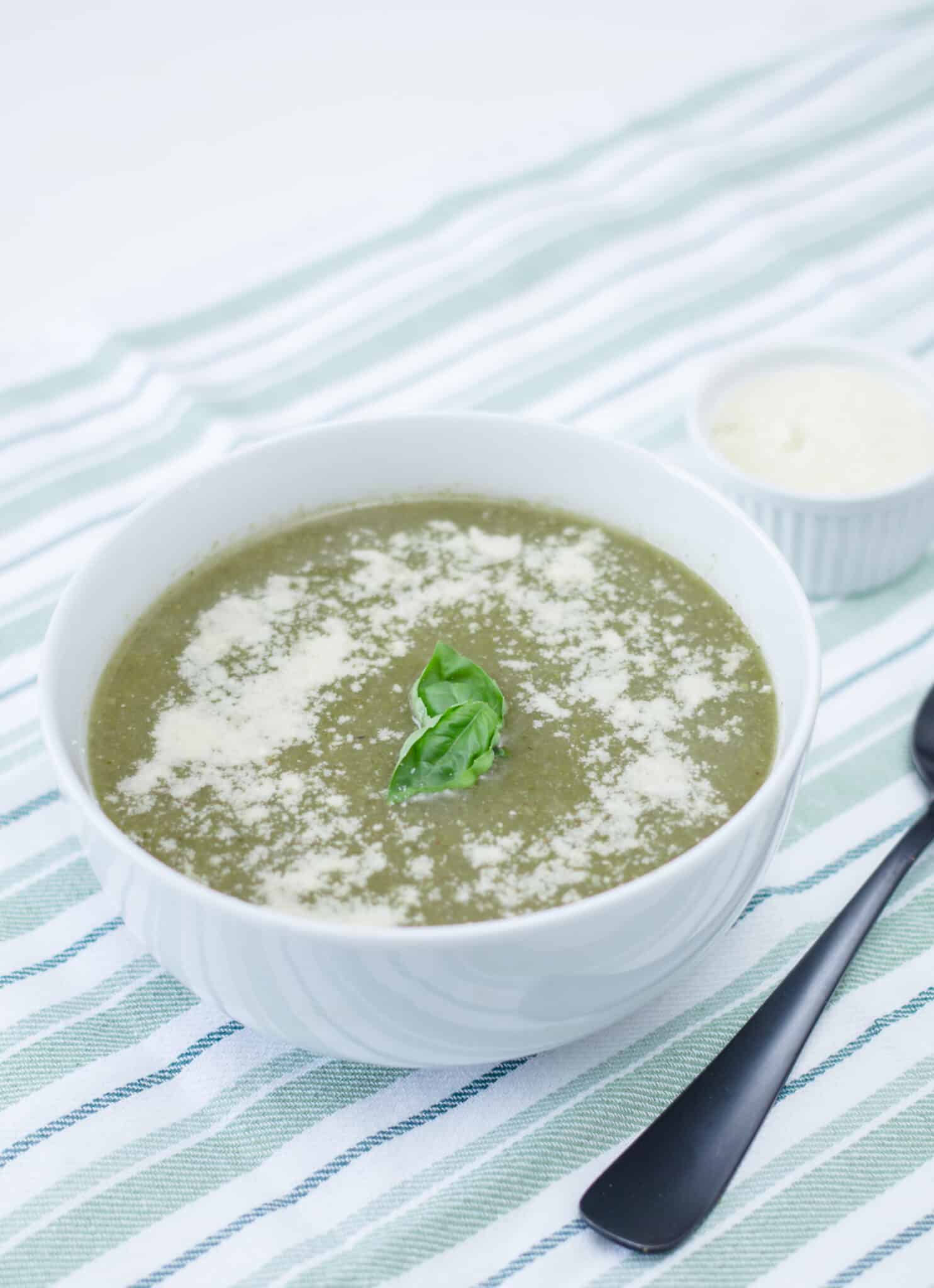 broccoli and parmesan soup in a white bowl