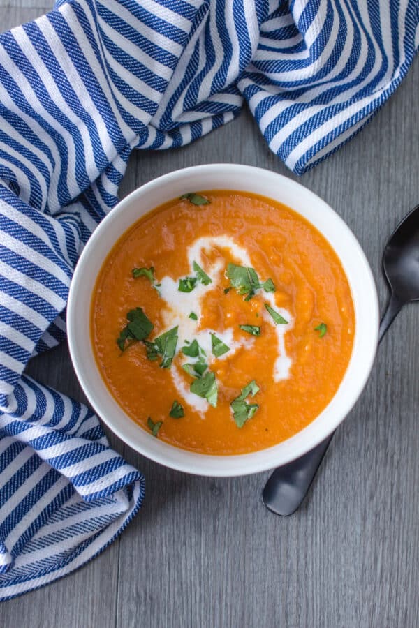 potato carrot soup on a table with a blue dish cloth 