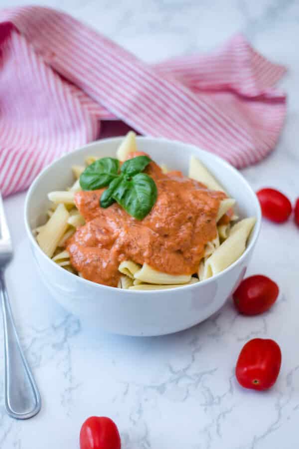 pasta with rose sauce in a white bowl