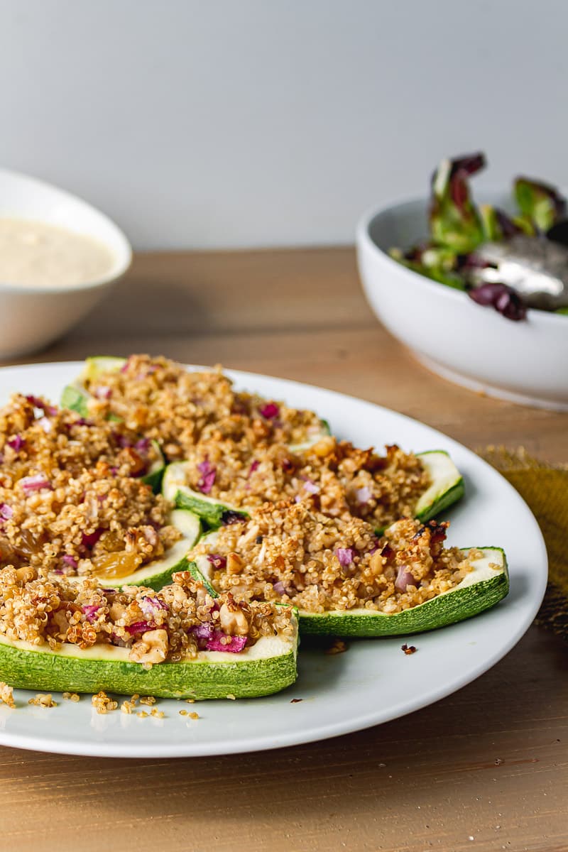 healthy stuffed zucchini served on a dish on wooden table