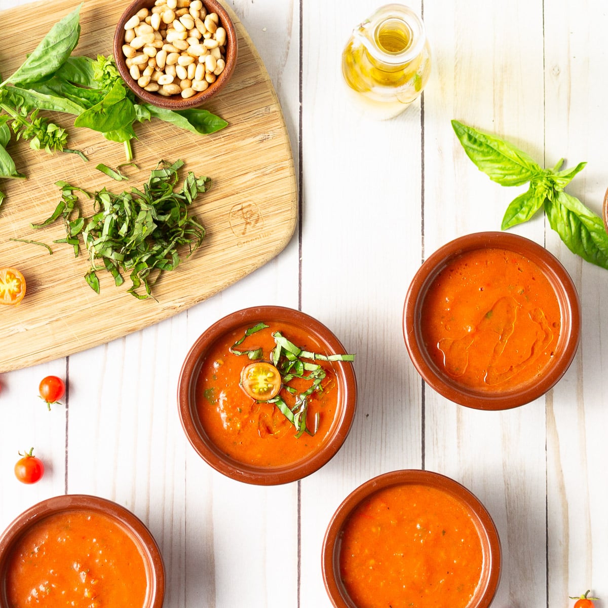 4 tomato gazpacho soup bowls on table