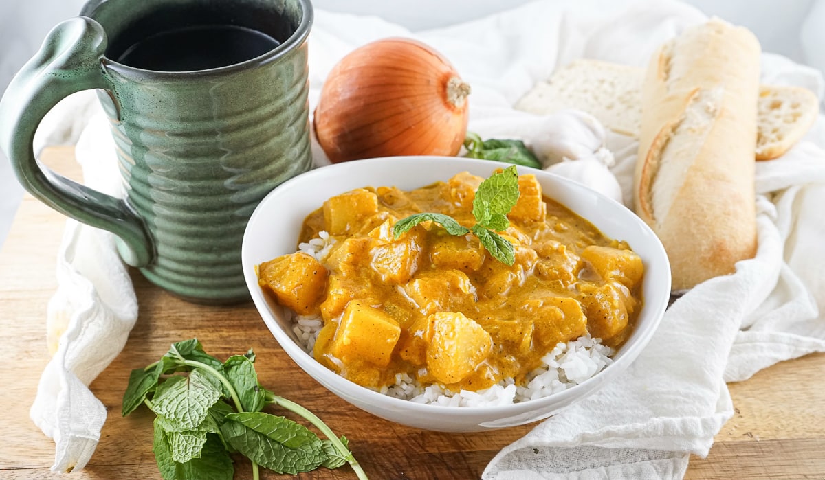 bowl of vegetarian pineapple curry with rice on table