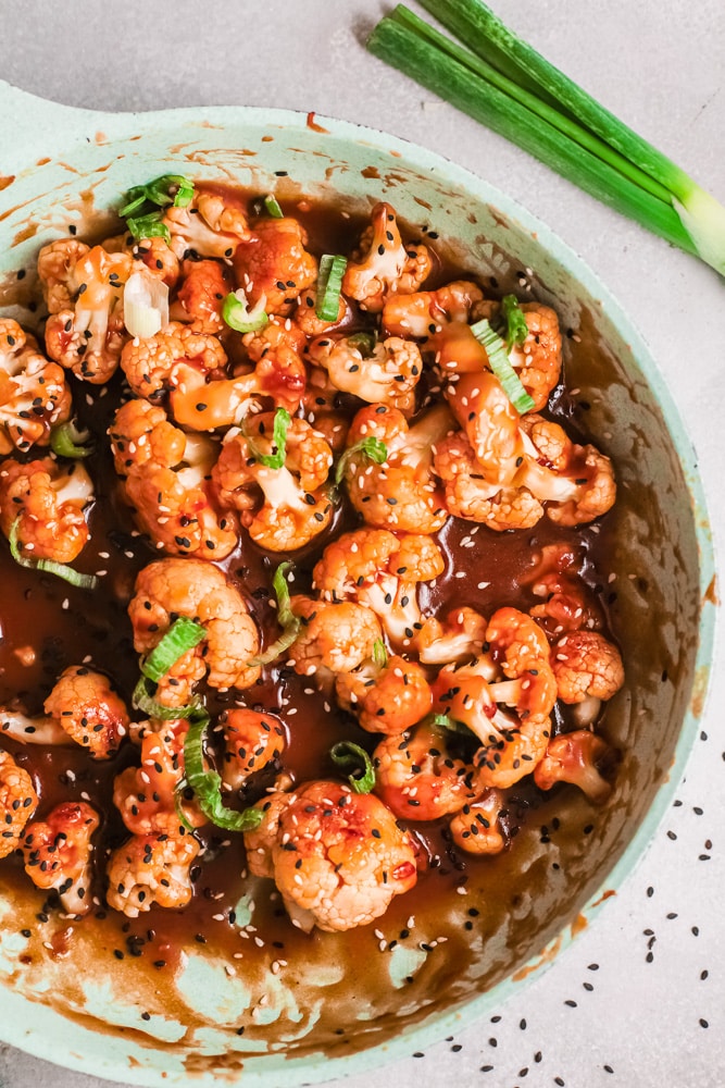 close up bowl of sticky sesame cauliflower