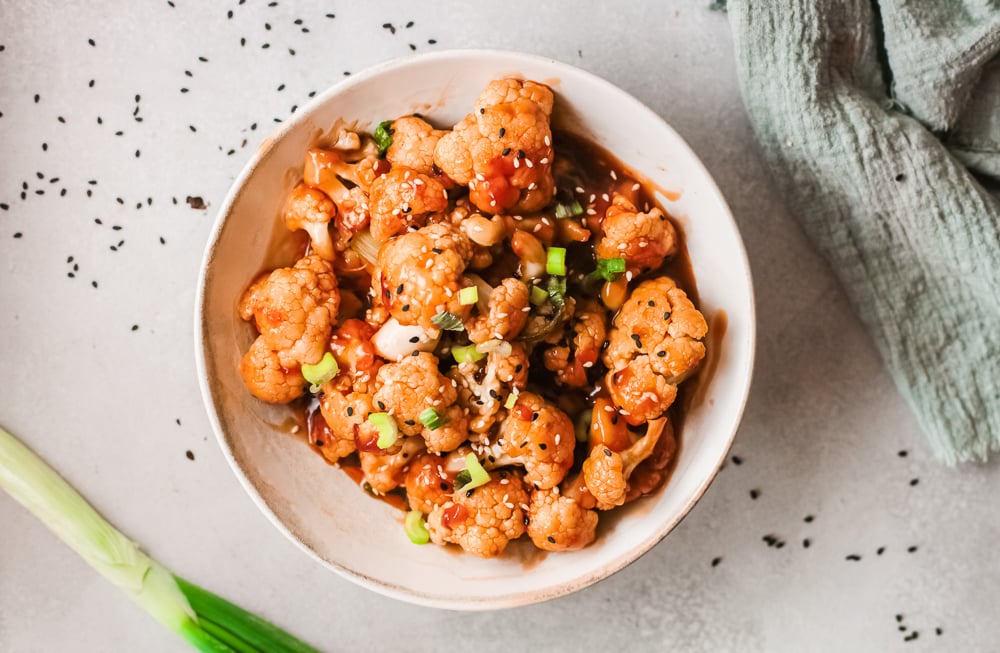 bowl of sticky sesame cauliflower on a table