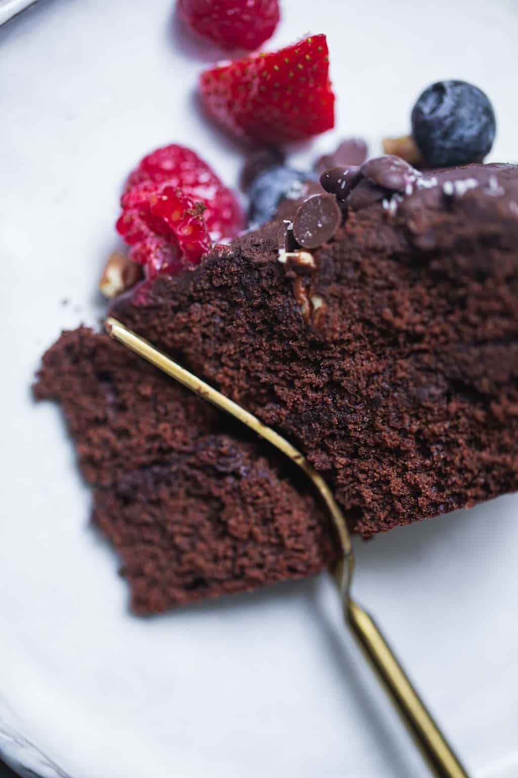 taking a bite of vegan chocolate cake with a fork