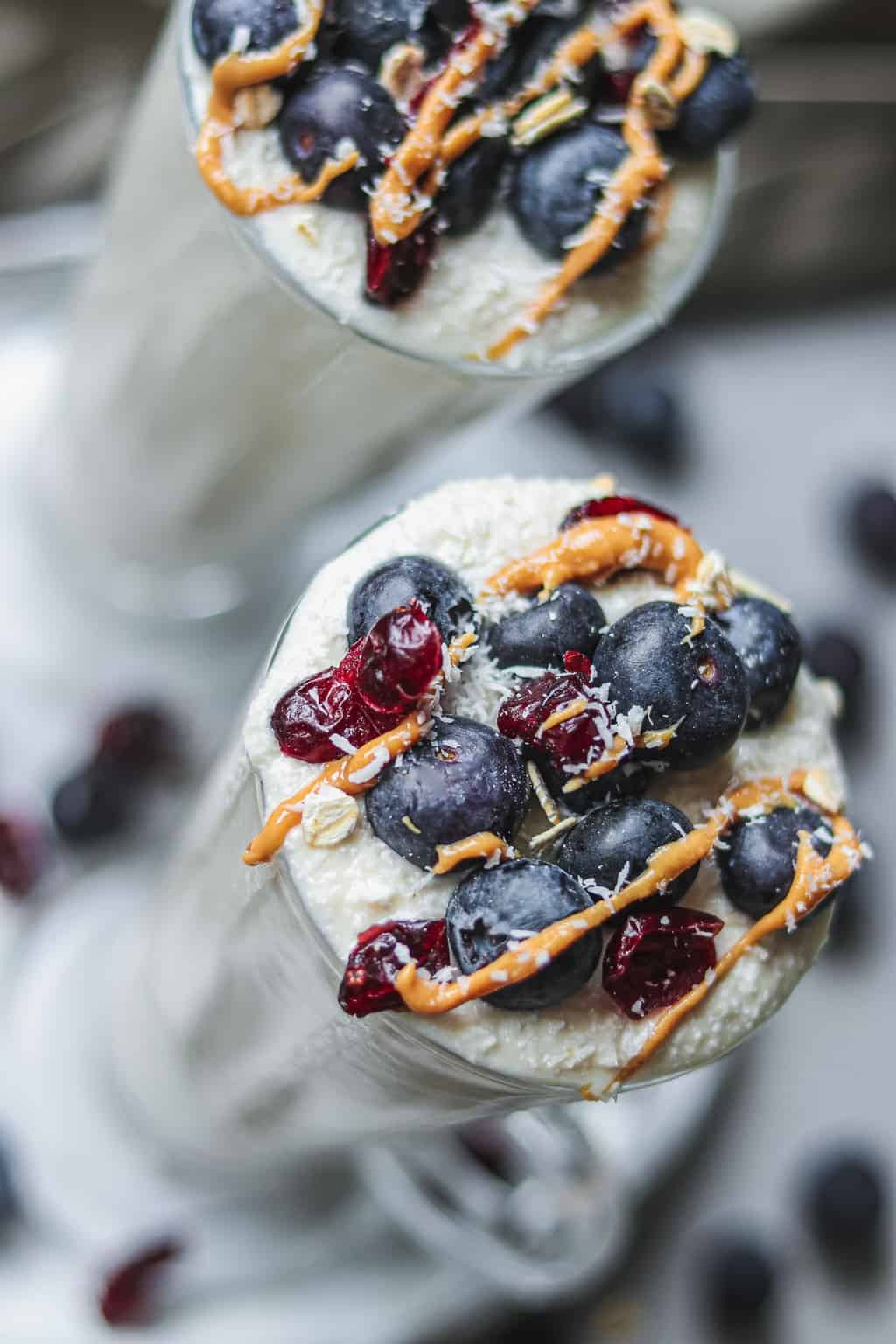 close up of vegan eggnog topped with berries and nut butter