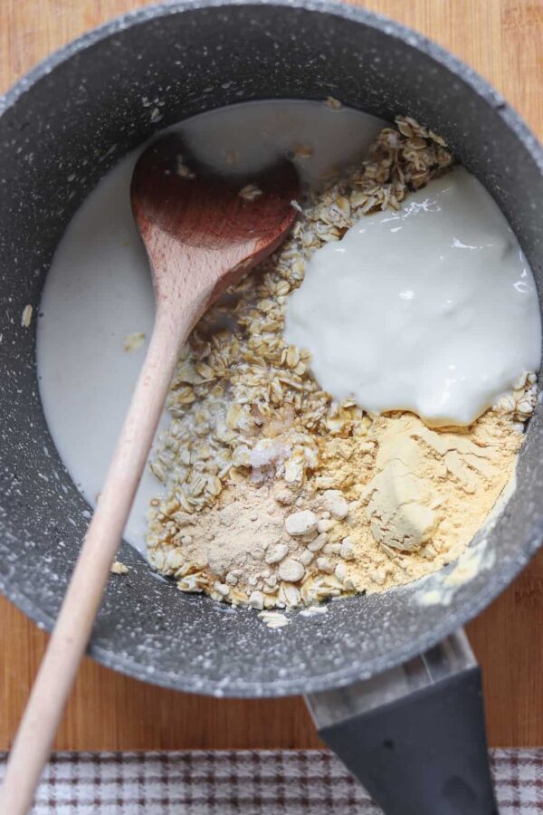 stirring vegan oatmeal on the stove in a pot