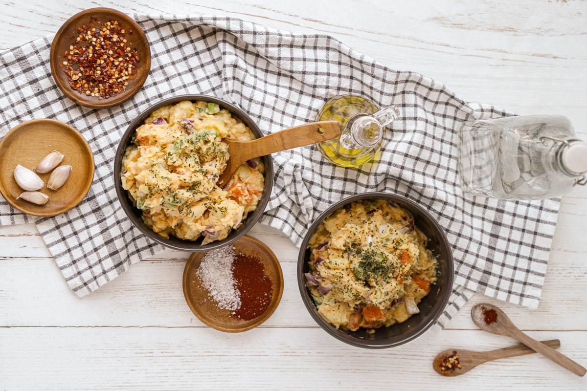 vegan potato salad on a table with cloth and condiments