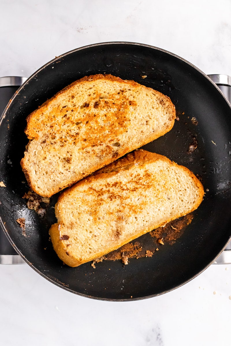 sourdough French toast cooking in a pan