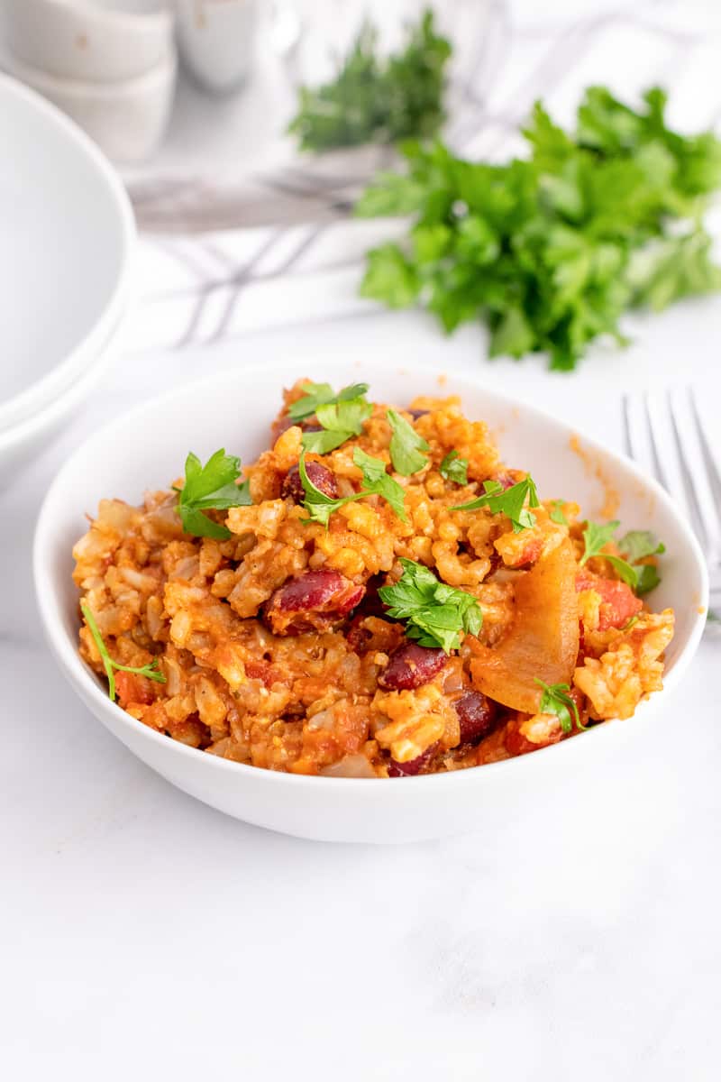 white bowl of Spanish Rice and beans on white table