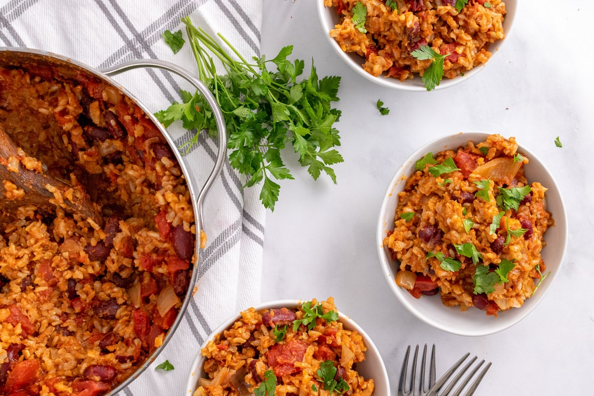 pot and three bowls of Spanish Rice and beans