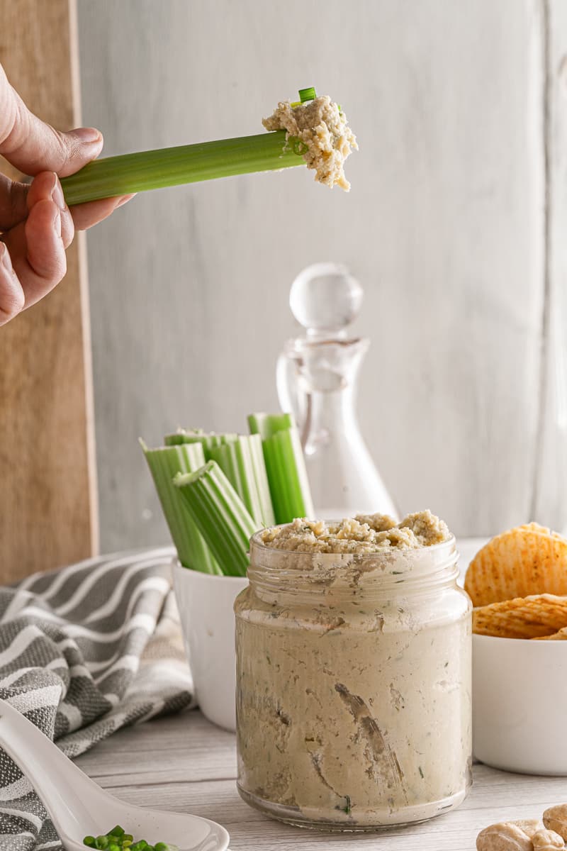 scooping up 15-minute cashew cheese with celery stick