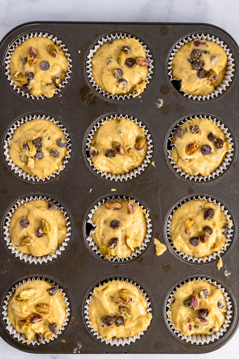 top view of unbaked pistachio muffins in muffin tray