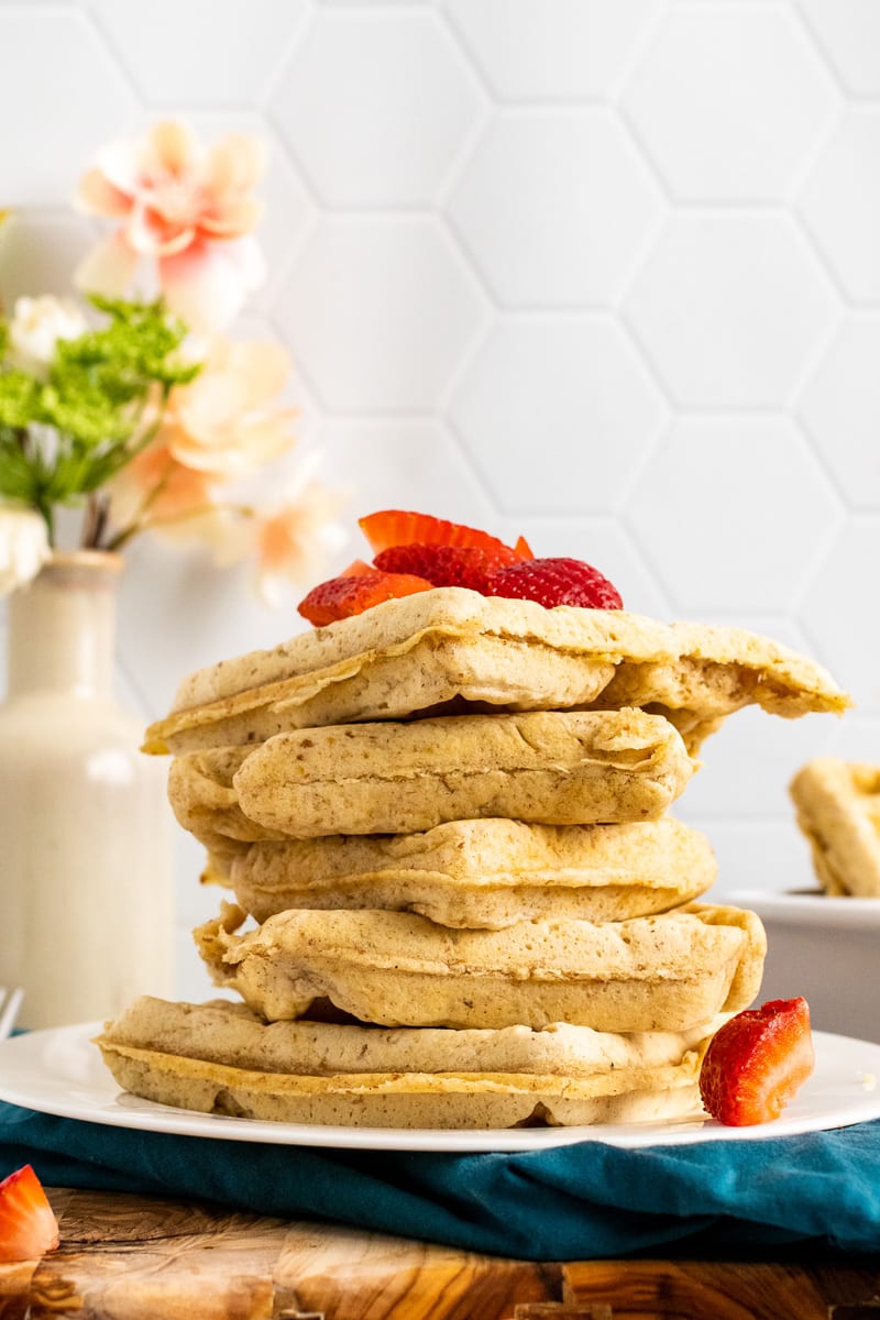 stack of vegan waffles with strawberries on top