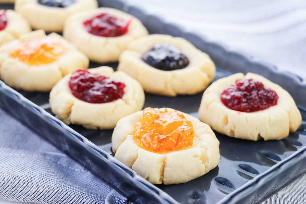 side view of nicely plated shortbread thumbprint cookies