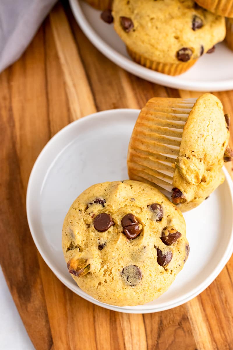 two chocolate chip banana bread muffins on a white plate