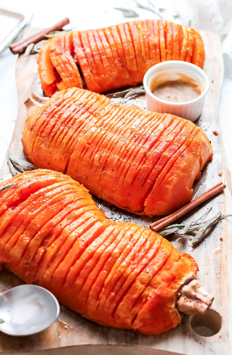 side view of 3 baked hasselback butternut squash halves